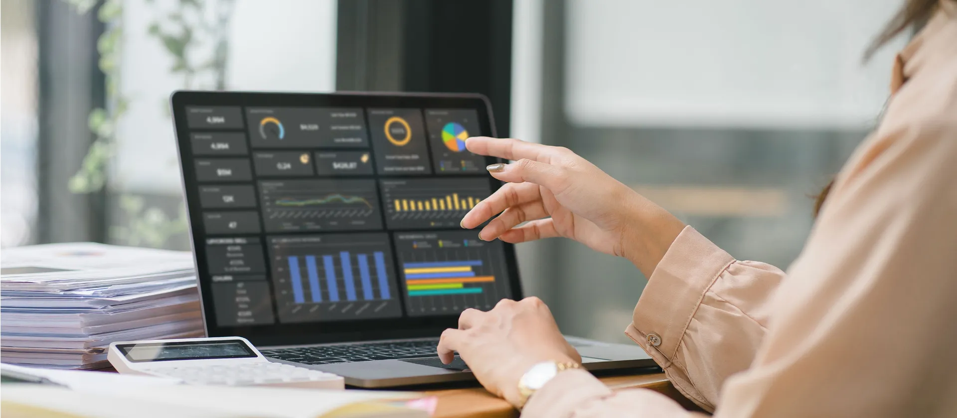 The female analyst utilizes a computer and a dashboard for business data analyze and a data management system with KPI. The concepts of technology, finance, operations, sales, and marketing. 