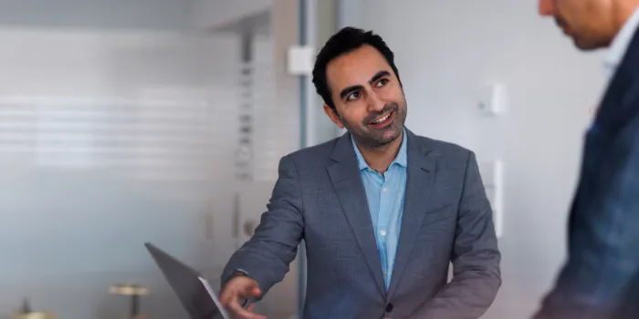 SAP consultant in a business meeting, discussing enterprise software solutions and digital transformation strategies in a modern office setting.