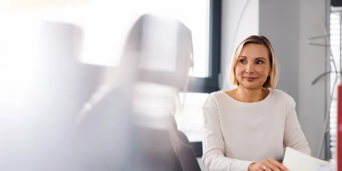 Professional businesswoman during a meeting, symbolizing collaboration, leadership, and strategic thinking in a modern office environment.