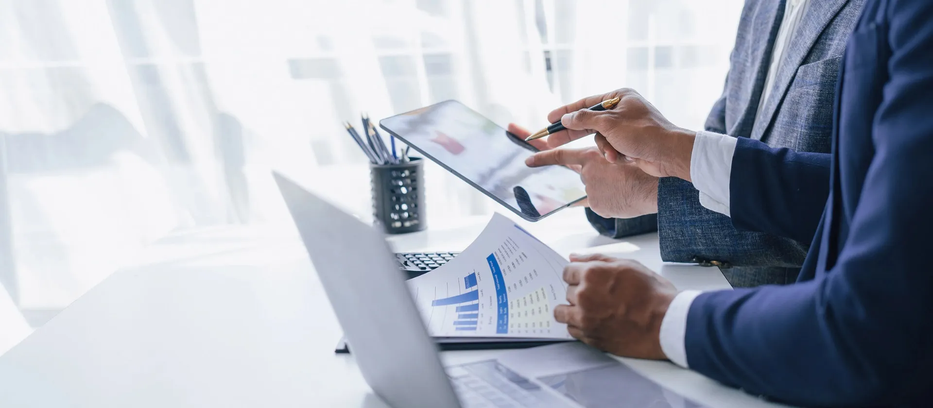 Businessmen going trough finance and tax reports.